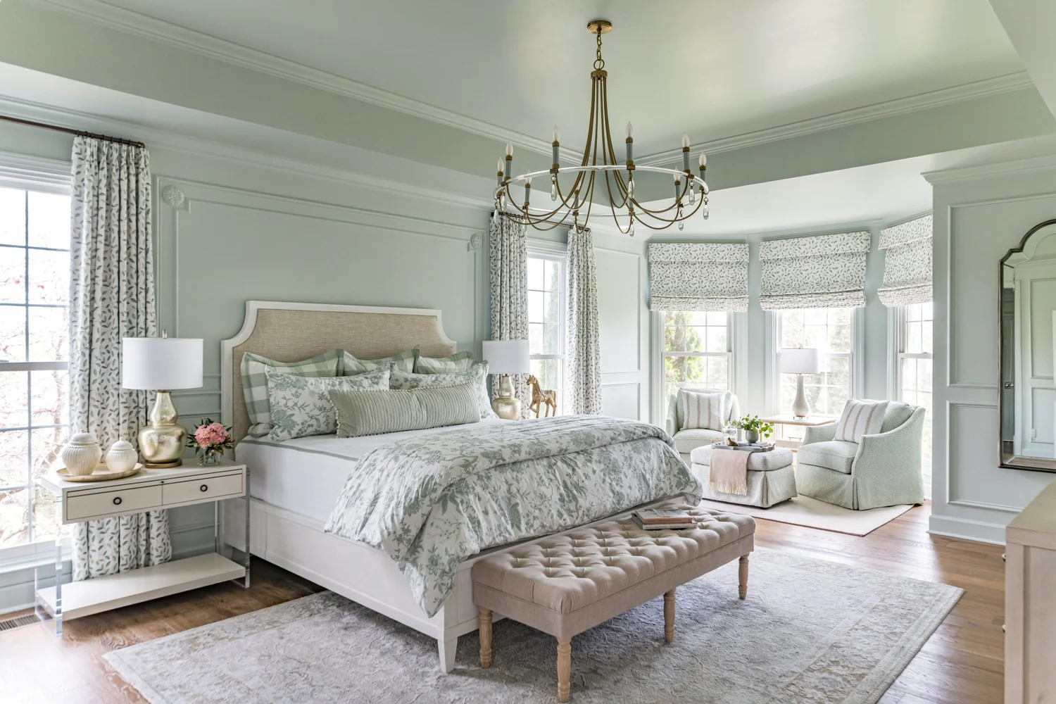 A primary bedroom in soft neutrals with a woven headboard and linen bedding